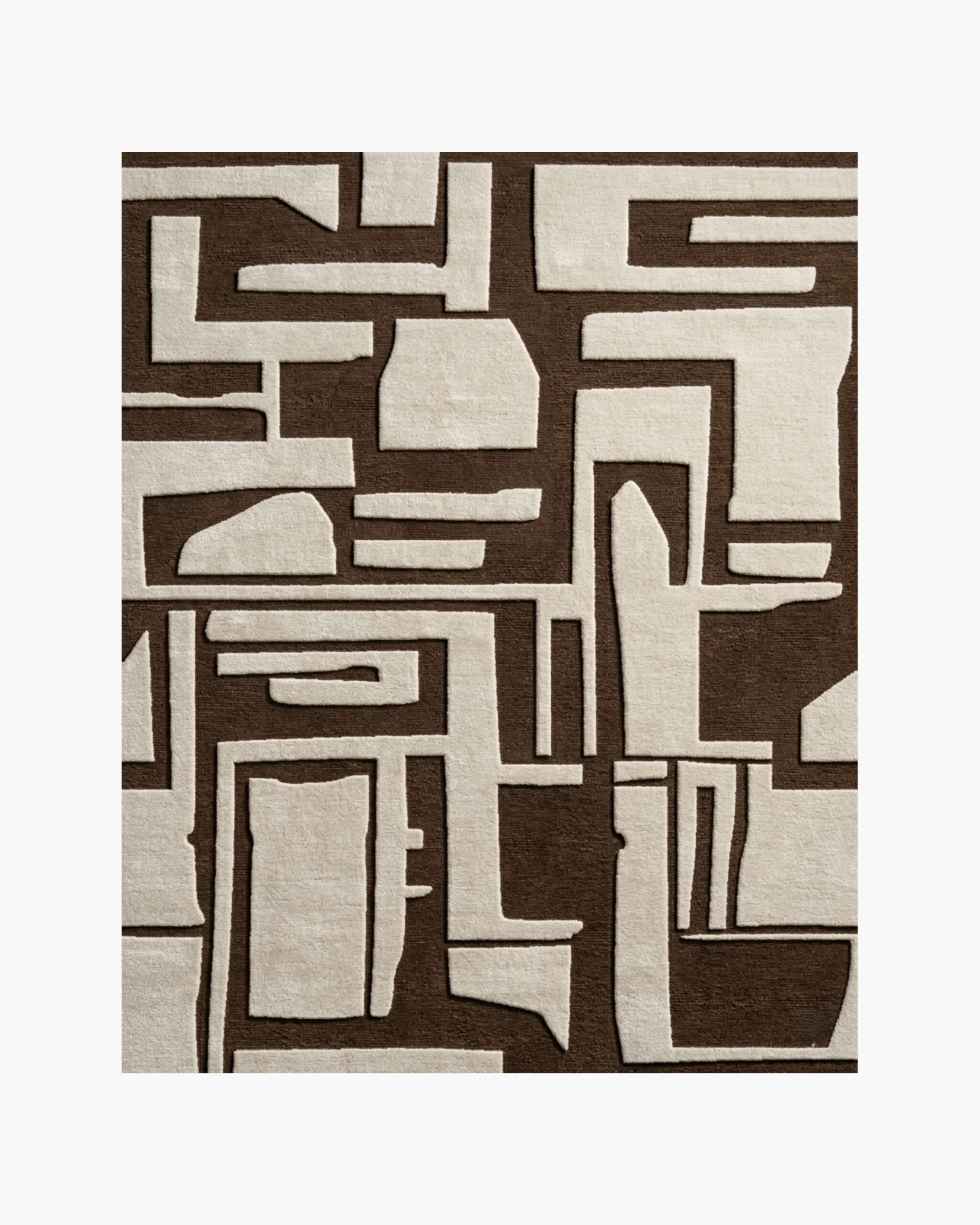 Adobe Glyph brown and cream tribal geometric wool rug Adobe Glyph brown and cream tribal geometric wool rug with carved maze-like shapes on a chocolate-brown ground