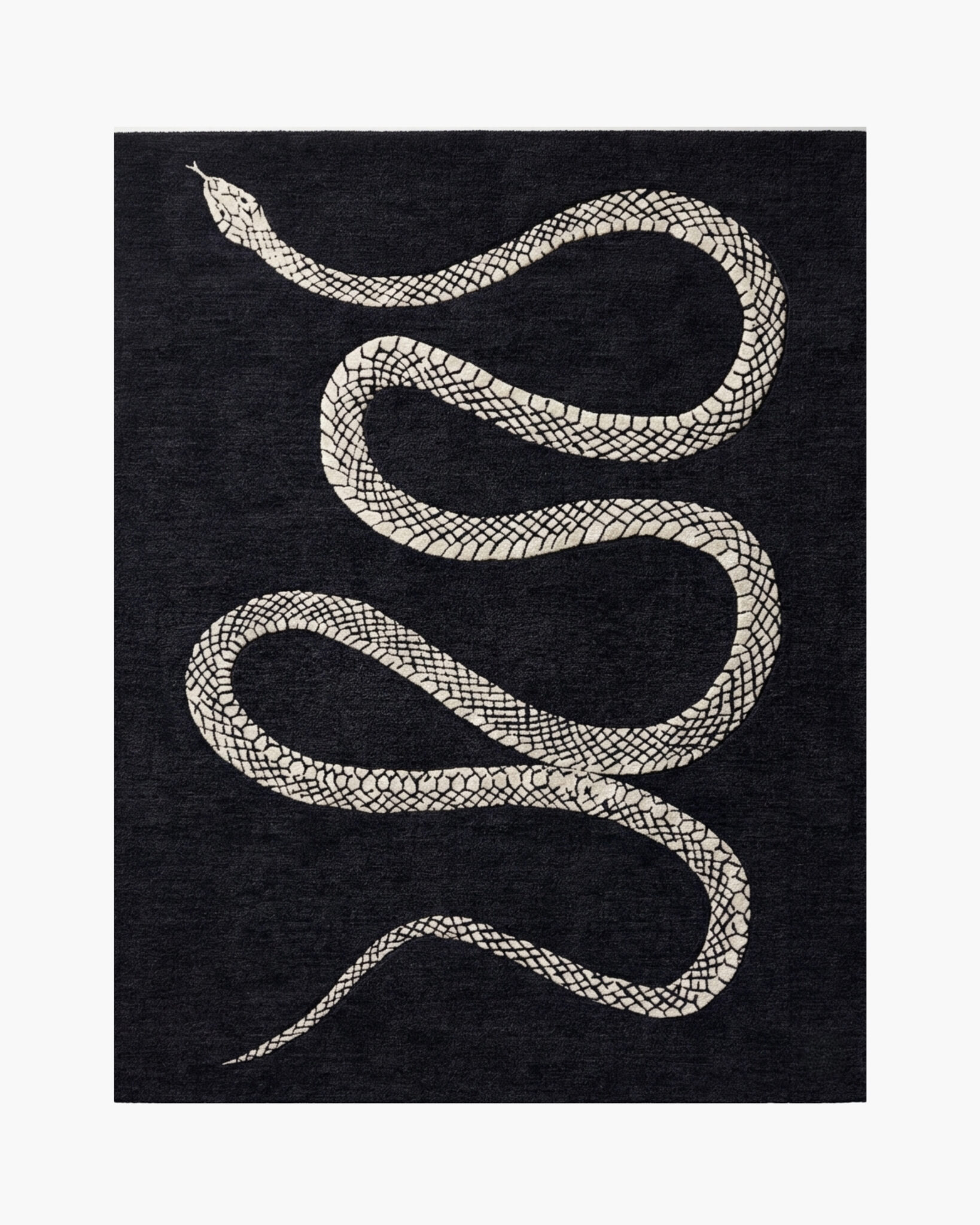 Serpentine Noir black and white snake wool rug with an ivory serpent winding down a charcoal-black ground