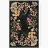 Midnight Garland black floral border rug with a wreath of roses and blossoms framing a black center