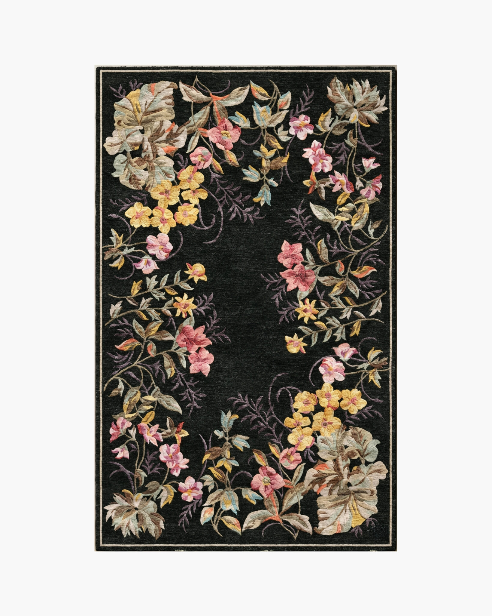 Midnight Garland black floral border rug with a wreath of roses and blossoms framing a black center