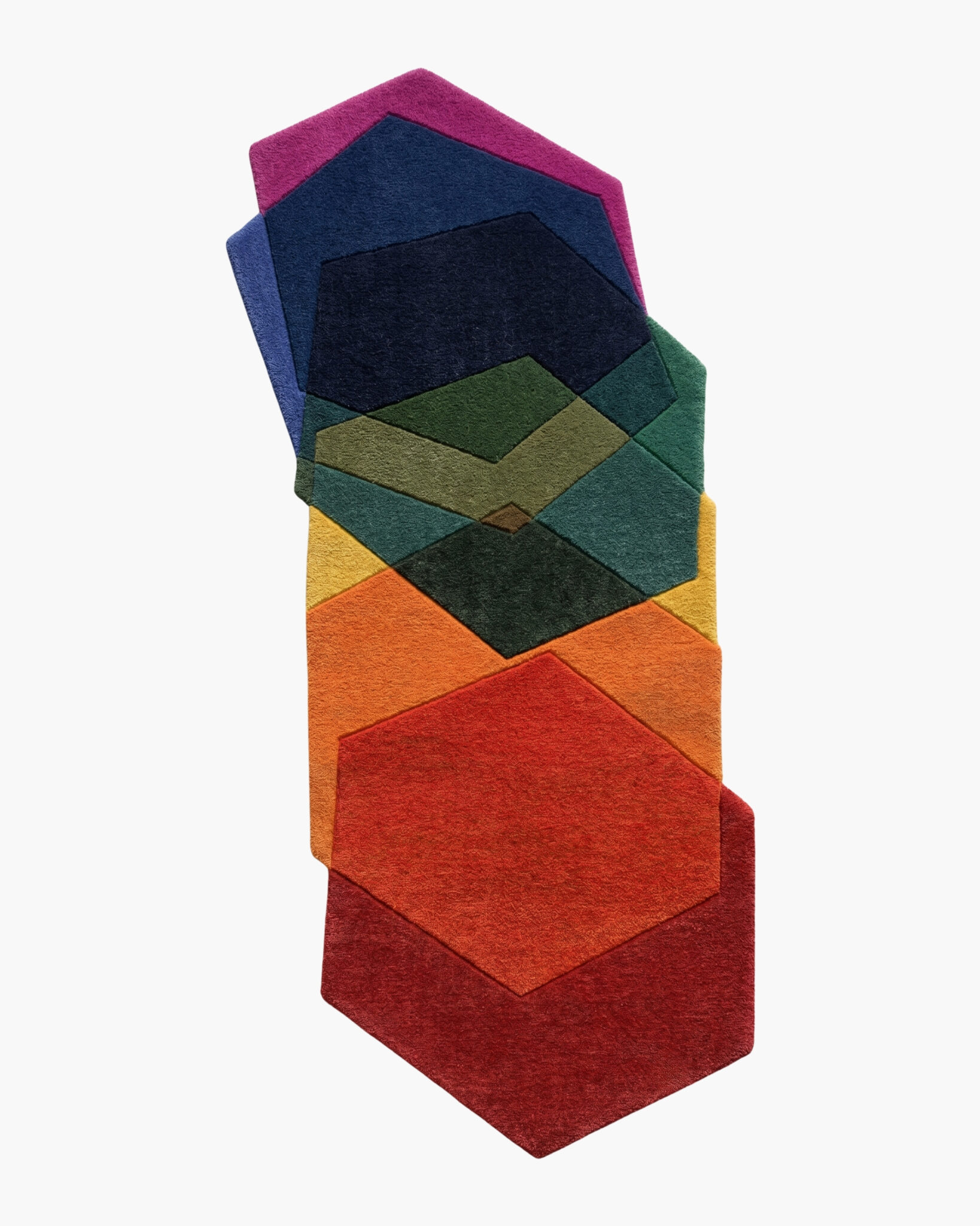 Prism Stack rainbow hexagon wool rug with six overlapping spectrum tiles in a stacked deckled shape