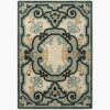 Traditional medallion rug in ivory with blue, black and gold ornamental scrollwork design